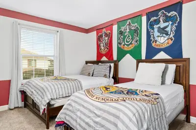 two beds in a room with flags on the wall at Really close to Disney! Sleeps 10 - STL116 in Kissimmee