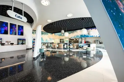 a lobby of a store with tables and chairs at Universal's Stella Nova Resort in Orlando