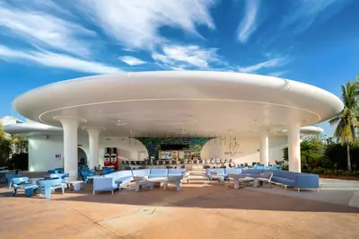 a large building with blue and white chairs and tables at Universal's Stella Nova Resort in Orlando