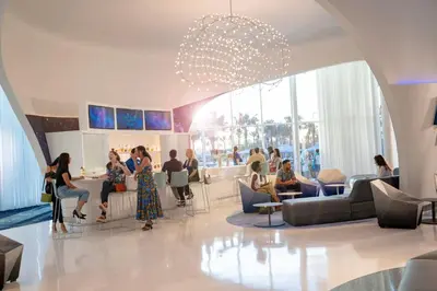 a rendering of a lobby with people sitting at Universal's Stella Nova Resort in Orlando