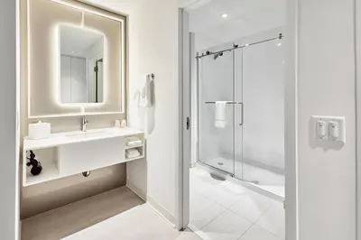 a white bathroom with a sink and a shower at Universal's Terra Luna Resort in Orlando