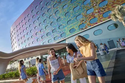 a group of women walking in front of a building at Universal's Terra Luna Resort in Orlando