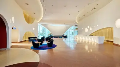 a lobby with chairs and tables in a building at Universal's Terra Luna Resort in Orlando