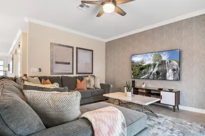 a living room with a couch and a ceiling fan at Home away from Home! 6BR, 5.5 BA - STL118 in Kissimmee