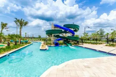 a water slide in a pool at a resort at Home away from Home! 6BR, 5.5 BA - STL118 in Kissimmee