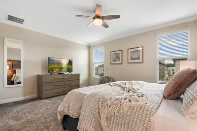 a bedroom with a bed and a ceiling fan at Home away from Home! 6BR, 5.5 BA - STL118 in Kissimmee