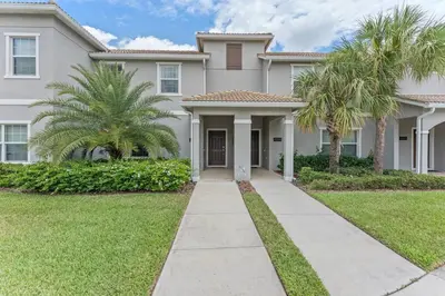 a house with palm trees in front of it at Lovely Family Home - 8 Min to Disney! - STL106 in Kissimmee