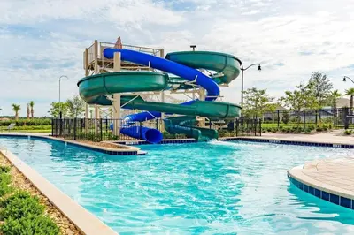 a water slide in a pool at a resort at Lovely Family Home - 8 Min to Disney! - STL106 in Kissimmee