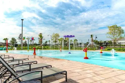 a large swimming pool with chairs and water fountains at Lovely Family Home - 8 Min to Disney! - STL106 in Kissimmee