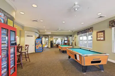 a billiard room with two pool tables and a arcade at Sunnyside Up Gated Resort Style Community in Orlando