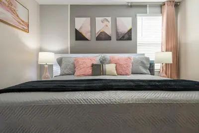 a bedroom with a large bed with two lamps at Luxury Lake View 9-Bedroom Villa @Storey Lake Resort in Kissimmee