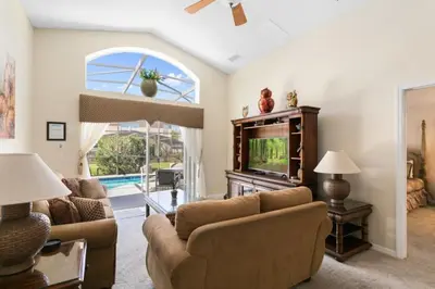 a living room with a couch and a tv at Florida Jewels - beautiful villa on Emerald Island in Kissimmee