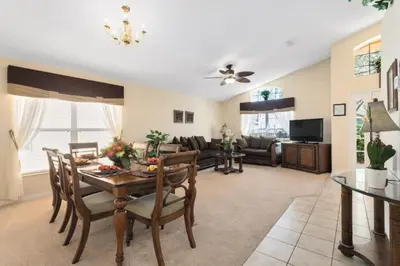 a living room with a table and a couch at Florida Jewels - beautiful villa on Emerald Island in Kissimmee