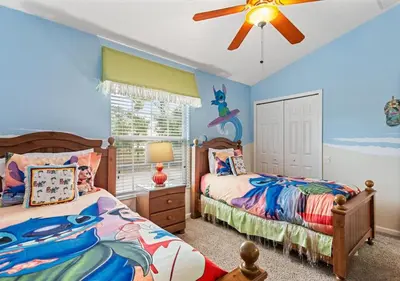 a bedroom with two beds and a ceiling fan at Lilo and stitch Ohana Oasis in Kissimmee