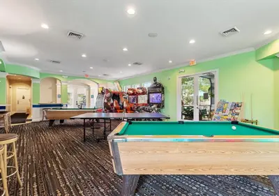 a billiard room with green walls and a pool table at Lilo and stitch Ohana Oasis in Kissimmee