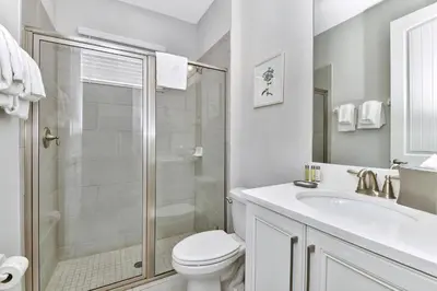 a bathroom with a shower and a toilet and a sink at Modern Home With Themed Rooms, Foosball Table And Waterpark & Resort Access Near Disney At Encore Resorts Reunion - 253Sf in Kissimmee
