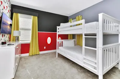 a bedroom with two bunk beds and a desk at Modern Home With Themed Rooms, Foosball Table And Waterpark & Resort Access Near Disney At Encore Resorts Reunion - 253Sf in Kissimmee