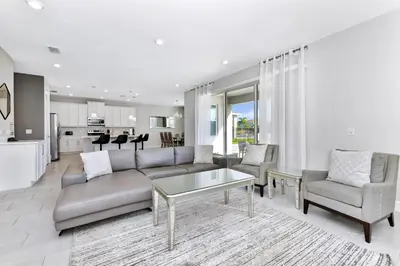a living room with a couch and a table at Modern Home With Themed Rooms, Foosball Table And Waterpark & Resort Access Near Disney At Encore Resorts Reunion - 253Sf in Kissimmee
