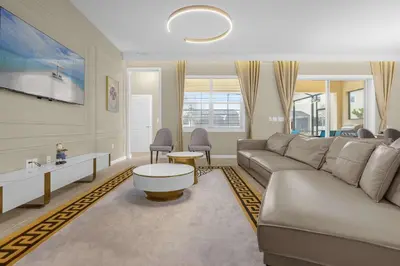 a living room with a couch and a table at 30-Guest Home w Theme Rooms Games Resort Access in Kissimmee