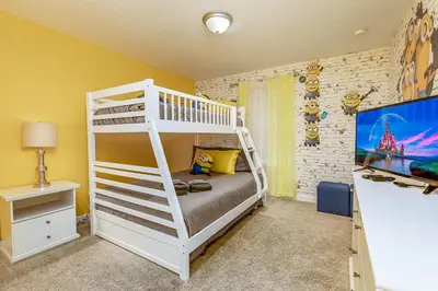 a bedroom with a bunk bed and a tv at Amazing Townhouse at Storey Lake Resort in Kissimmee