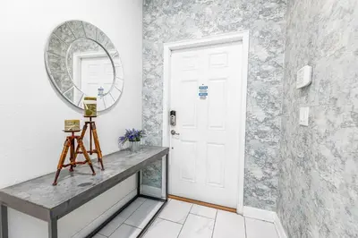 a hallway with a white door and a mirror at Amazing Townhouse at Storey Lake Resort in Kissimmee