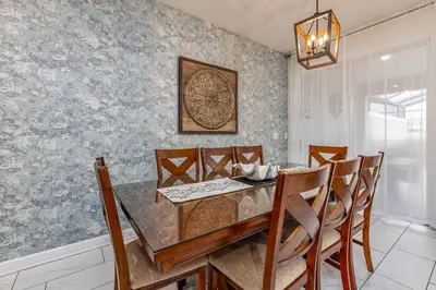 a dining room with a table and chairs at Amazing Townhouse at Storey Lake Resort in Kissimmee
