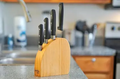 a wooden knife block on a counter in a kitchen at Esmerald Island Resort Oasis: Your Perfect Getaway Near Disney in Kissimmee