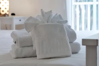 a pile of towels sitting on top of a bed at Esmerald Island Resort Oasis: Your Perfect Getaway Near Disney in Kissimmee