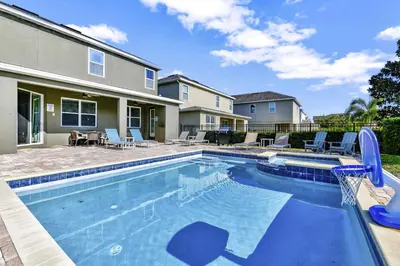 a swimming pool with a basketball hoop in front of a house at Gorgeous Home With Private Pool, Game Room Near Disney With Waterpark & Resort Access At Encore Resort - 781La in Kissimmee