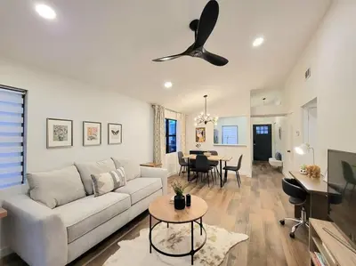 a living room with a couch and a ceiling fan at Elegant Cozy Spot to unwind! UCF/MCO/Parks/Beach in Orlando