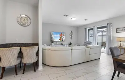 a living room with a sink and a table and chairs at Amazing 6Bdrms At Storey Lake- Close to Disney in Kissimmee