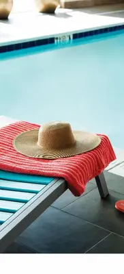 a hat sitting on top of a bed at Home2 Suites By Hilton Winter Garden in Orlando