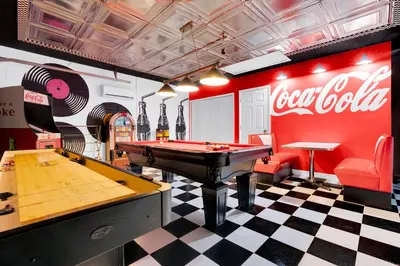 a billiard room with a pool table and a coca cola wall at South Facing Pool with Spa and a Game Room in Prime Location Near Disney in Kissimmee