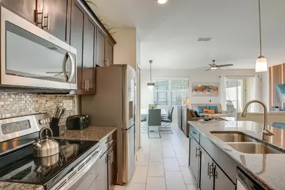 a kitchen with a sink and a stove top oven at Kissimmee Getaway with Pool Access 5 Mi to Disney in Kissimmee