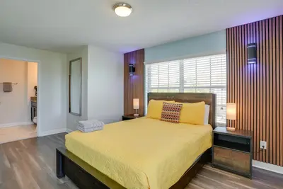 a bedroom with a bed with yellow sheets and a window at Kissimmee Getaway with Pool Access 5 Mi to Disney in Kissimmee