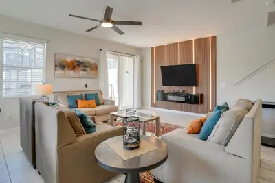 a living room with two couches and a flat screen tv at Kissimmee Getaway with Pool Access 5 Mi to Disney in Kissimmee