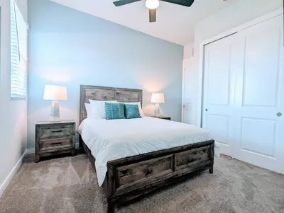 a bedroom with a bed and two night stands with lamps at Cozy 2024 New 3 Suites 5 min to Disney in Orlando