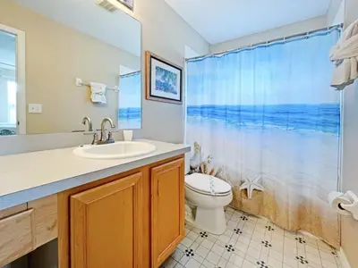 a bathroom with a sink and a toilet and a shower at Sunnyside Villa home in Kissimmee