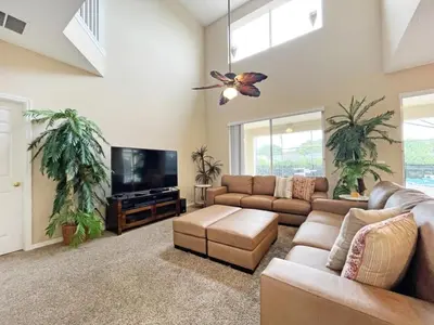 a living room with a couch and a flat screen tv at Sunnyside Villa home in Kissimmee