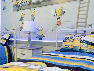 a bedroom with a bed with minions on the wall at 6BR w Heated Pool + 9MI to Disney + Sleeps 14 in Kissimmee