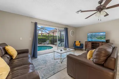 a living room with a couch and a tv at 4BR w Heated Pool near Disney & Lake - Sleeps 10 in Kissimmee