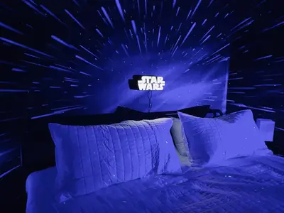 a bedroom with a bed with a star wars sign on the wall at Enchanted Hideaway in Kissimmee