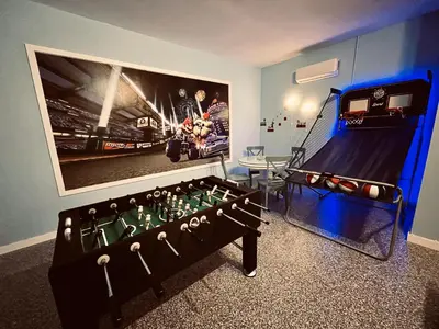 a room with a table and a giant video game at Enchanted Hideaway in Kissimmee