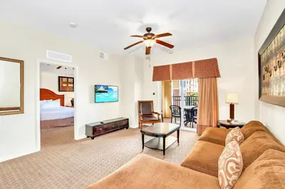 a living room with a couch and a bed at Cozy 2BR Condo Resort Spa with Pirate Pool in Kissimmee