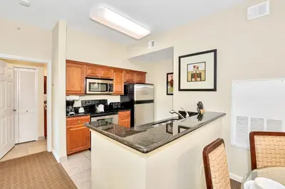 a kitchen with a sink and a counter top at Cozy 2BR Condo Resort Spa with Pirate Pool in Kissimmee