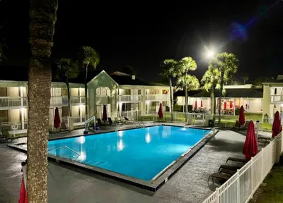 a swimming pool at night in a resort at Pool - WiFi - Parking - Best Location ! in Kissimmee
