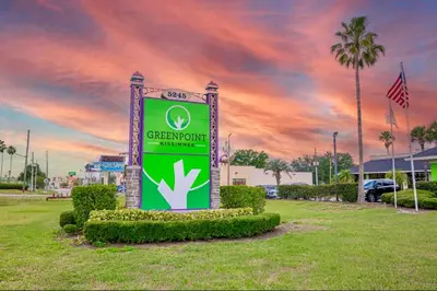 a sign in a park with a sunset in the background at Pool - WiFi - Parking - Best Location ! in Kissimmee