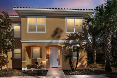 a house with palm trees in front of it at Comfortable 3BdrmsPrivate Hot TubClose to Disney in Kissimmee