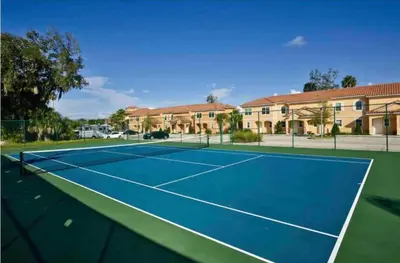 a tennis court in front of a building at Comfortable 3BdrmsPrivate Hot TubClose to Disney in Kissimmee