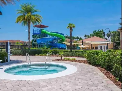 a pool in a playground with a water slide at Comfortable 3BdrmsPrivate Hot TubClose to Disney in Kissimmee
